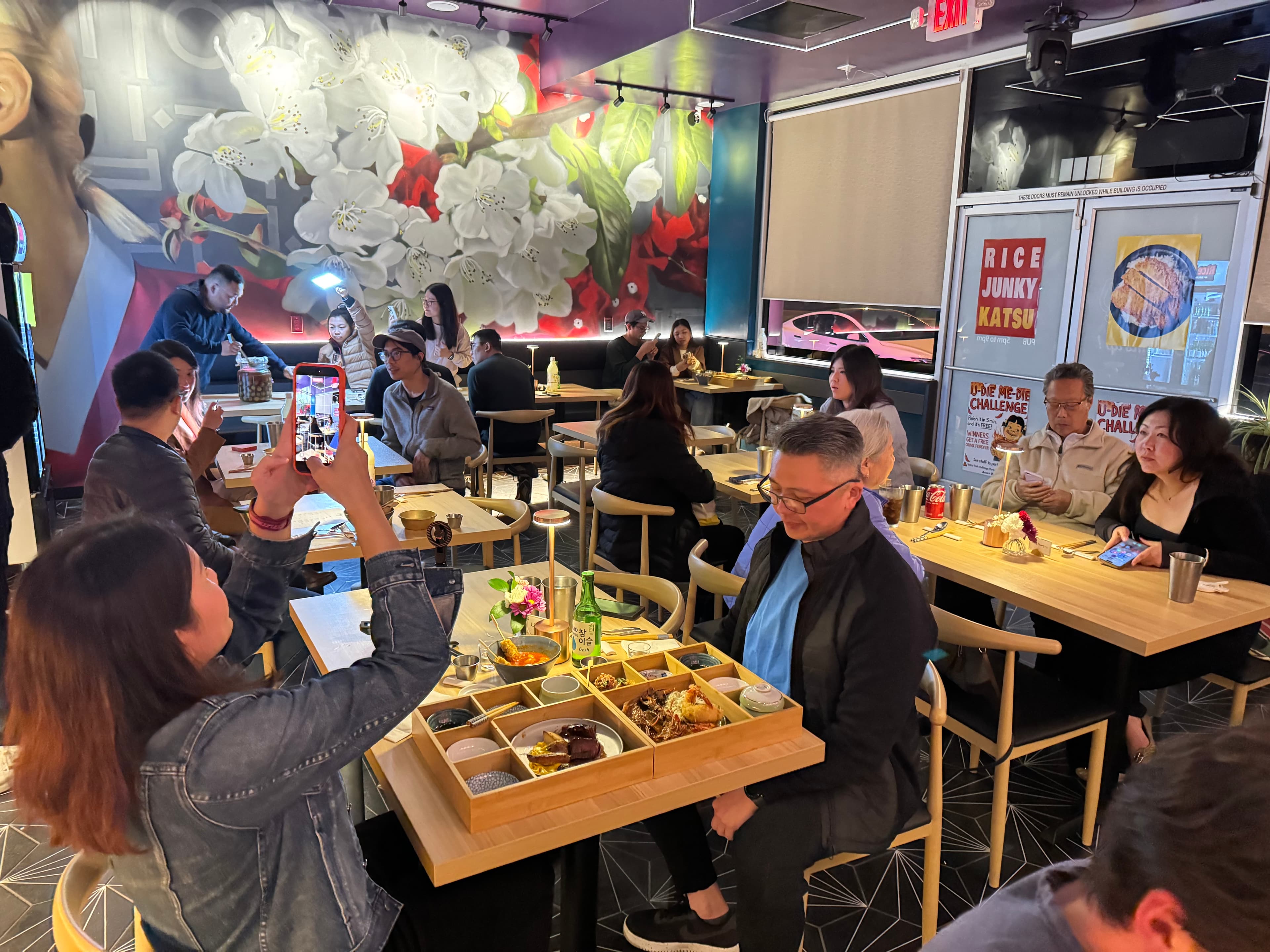 A customer at a packed Rice Junky dining room